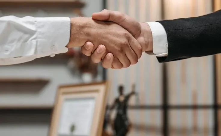 a handshake over a desk