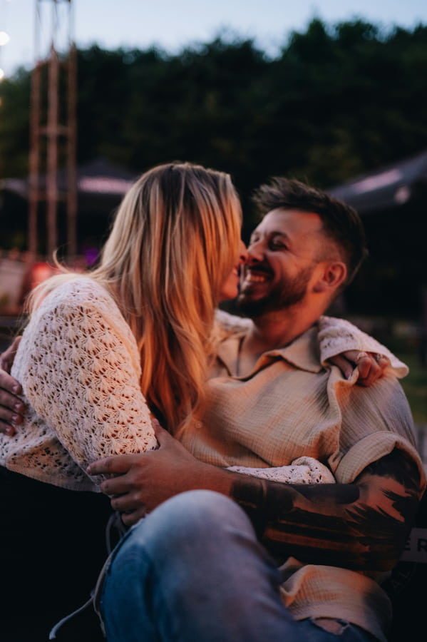 A woman and a man smiling outside
